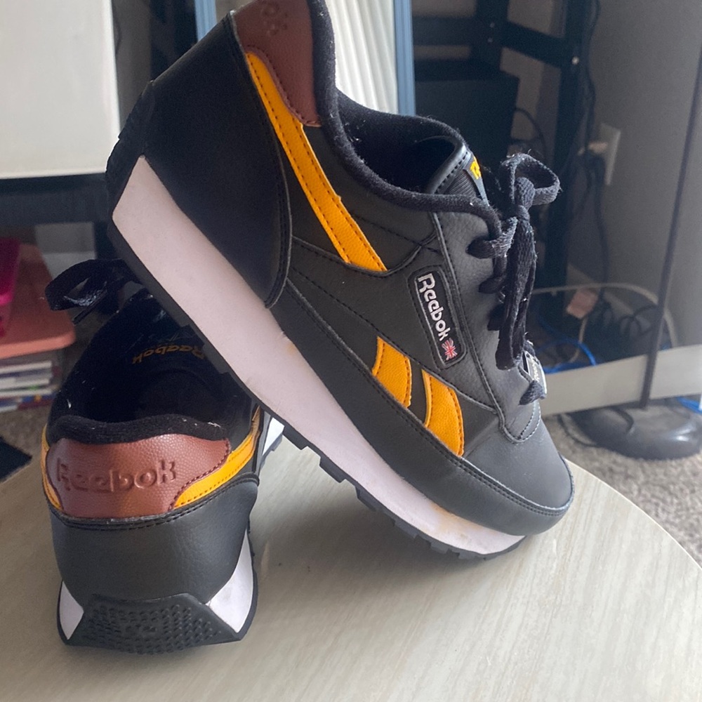 Black/ gold/ white Reebok tennis shoe